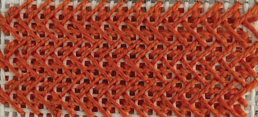Alternating Nobuko stitch in orange thread, the diagonal reversing between rows for a more even, less directional surface.