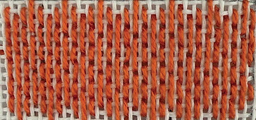 The Hungarian stitch, a medium-scale member of the needlepoint stitches in Volume 1, worked in orange thread.